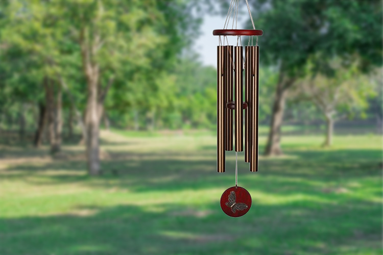 A windchime hanging in a yard