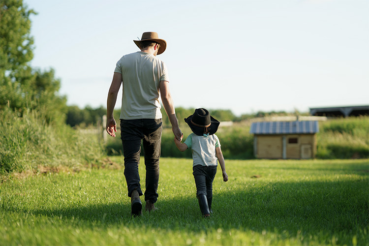 Father and son walking in a field